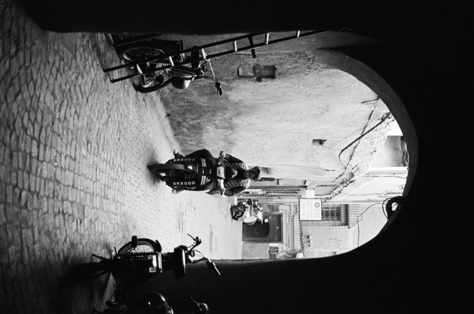 black and white photo of man on scooter in Marrakesh shot on 35mm film