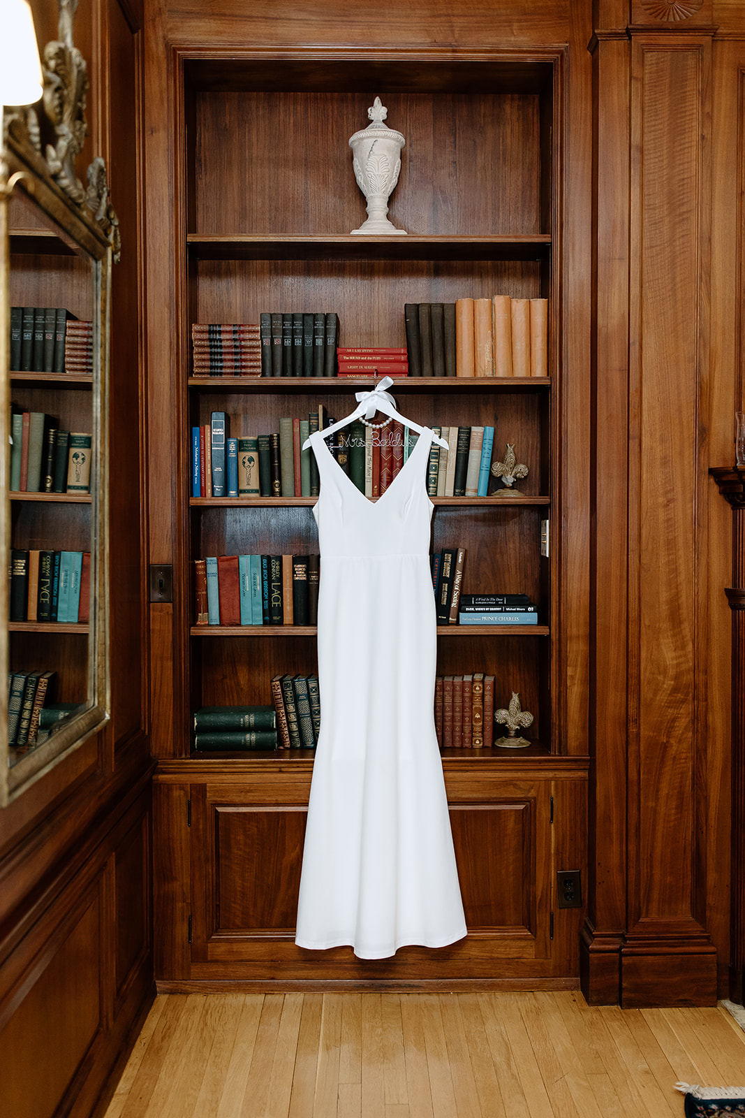Wedding dress hanging from a bookshelf