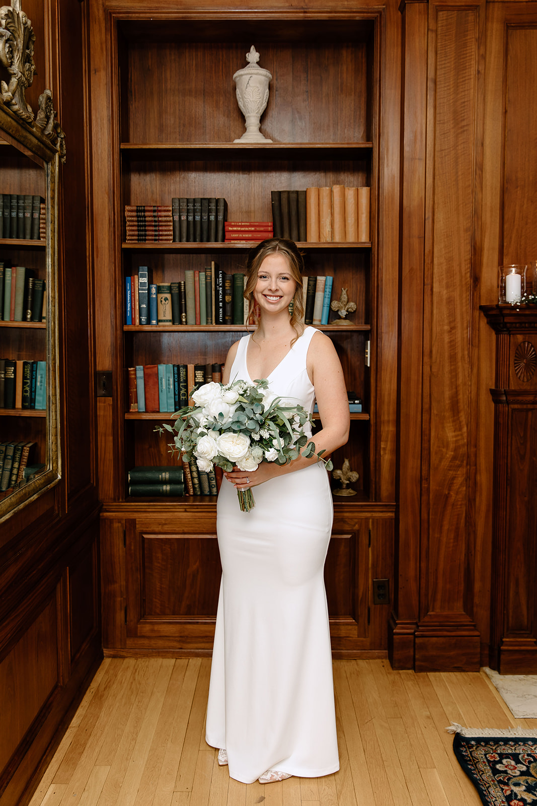 Bride in front of bookshelf