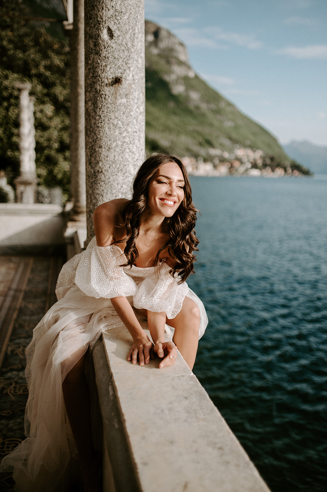 bride laughing looking out at views of lake como