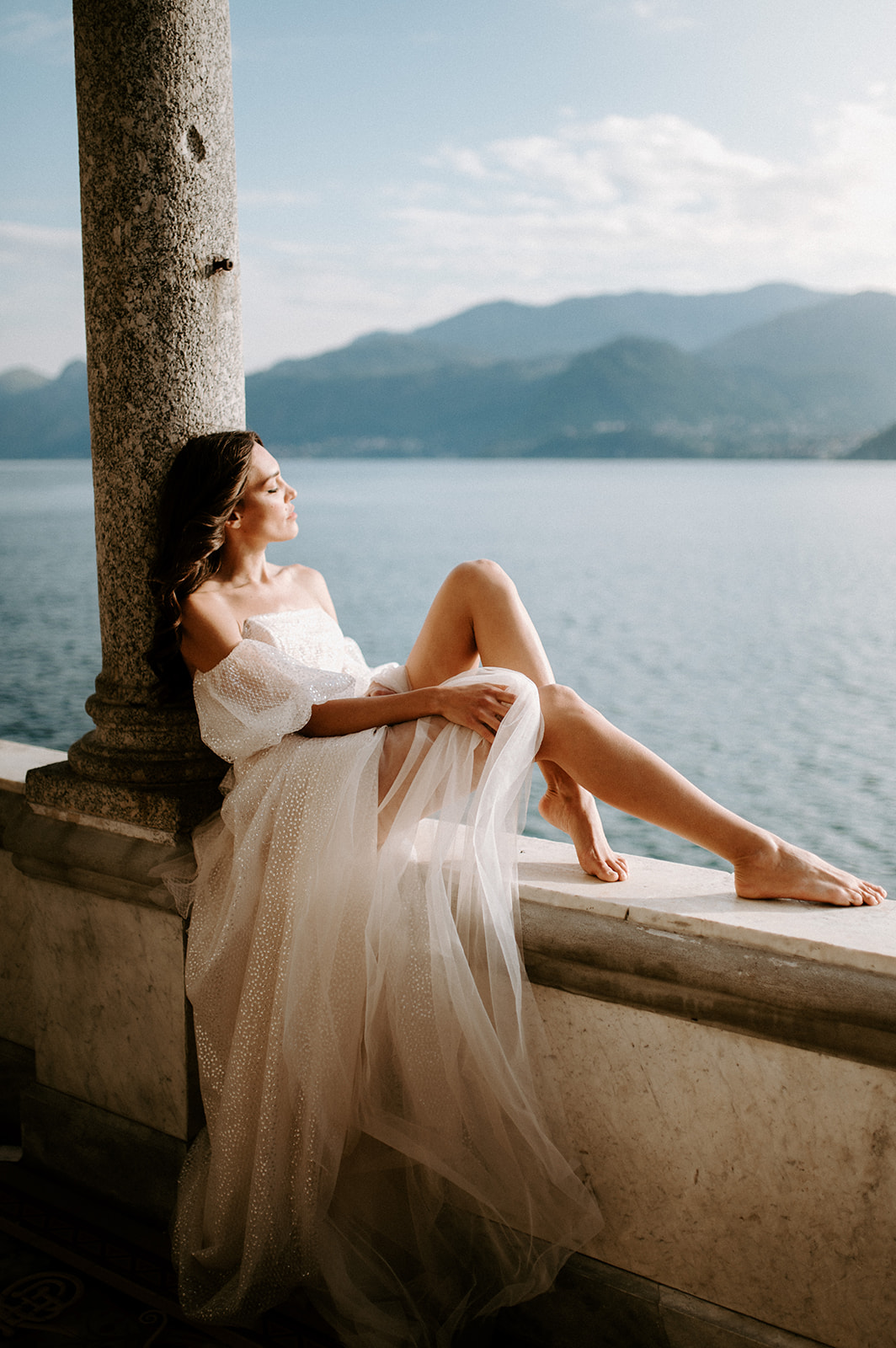 bride sitting looking out at views of lake como