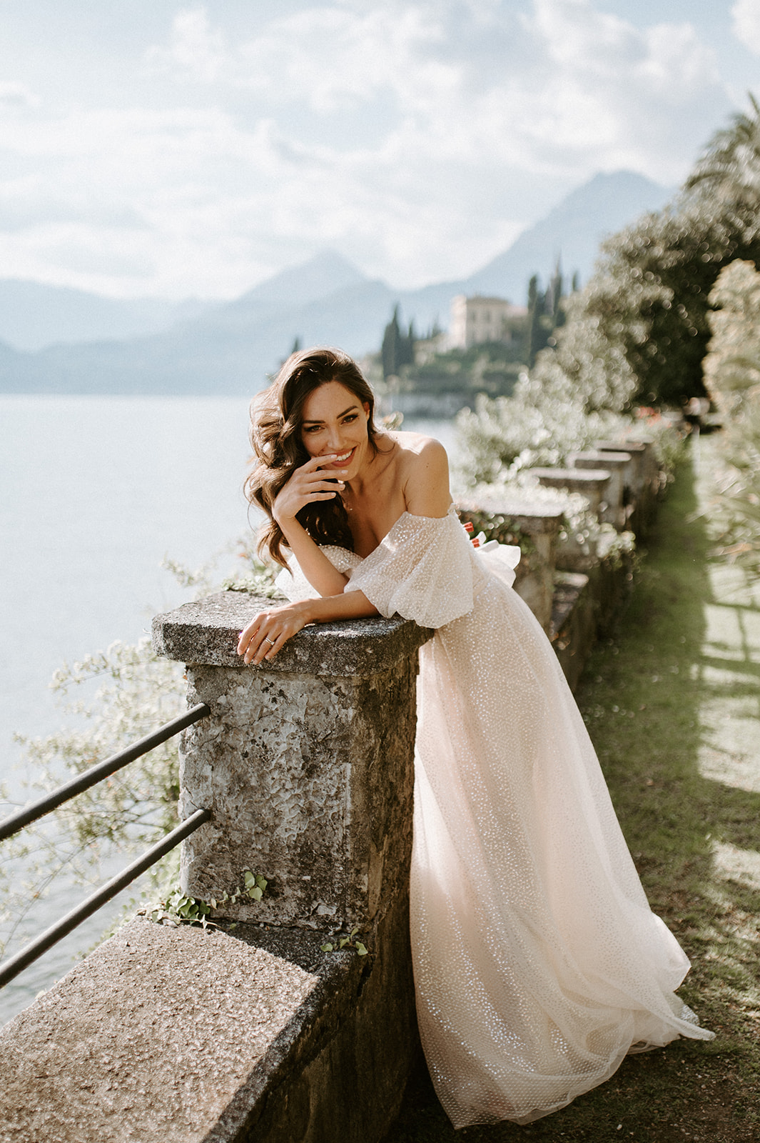 bride posing at lake Como with varenna in background