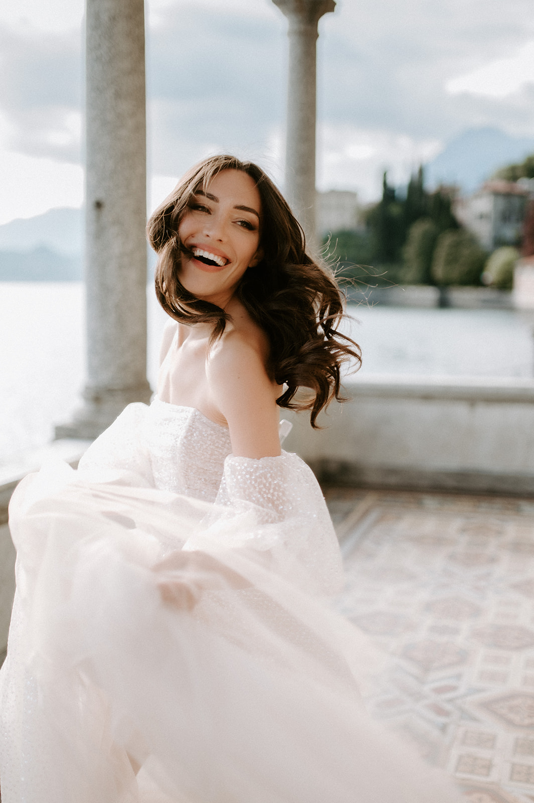 bride laughing at lake Como at villa monastero wearing jolie by berta