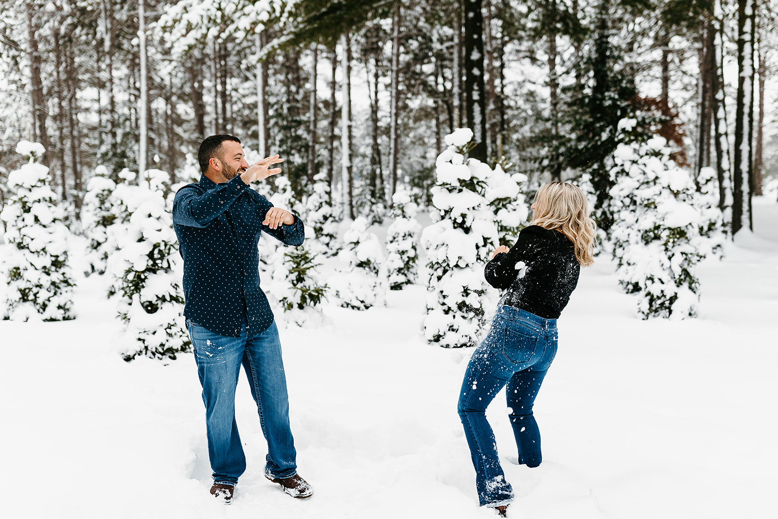 couple having a snowball fight in the snow