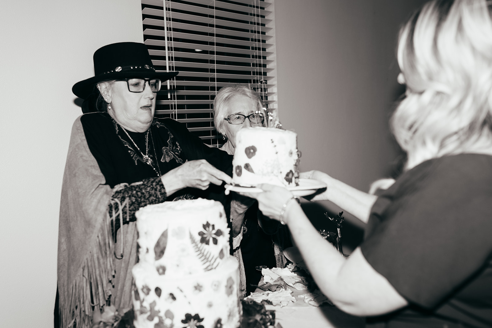 Elderly women cutting off the cake top at a wedding in Austin, Texas