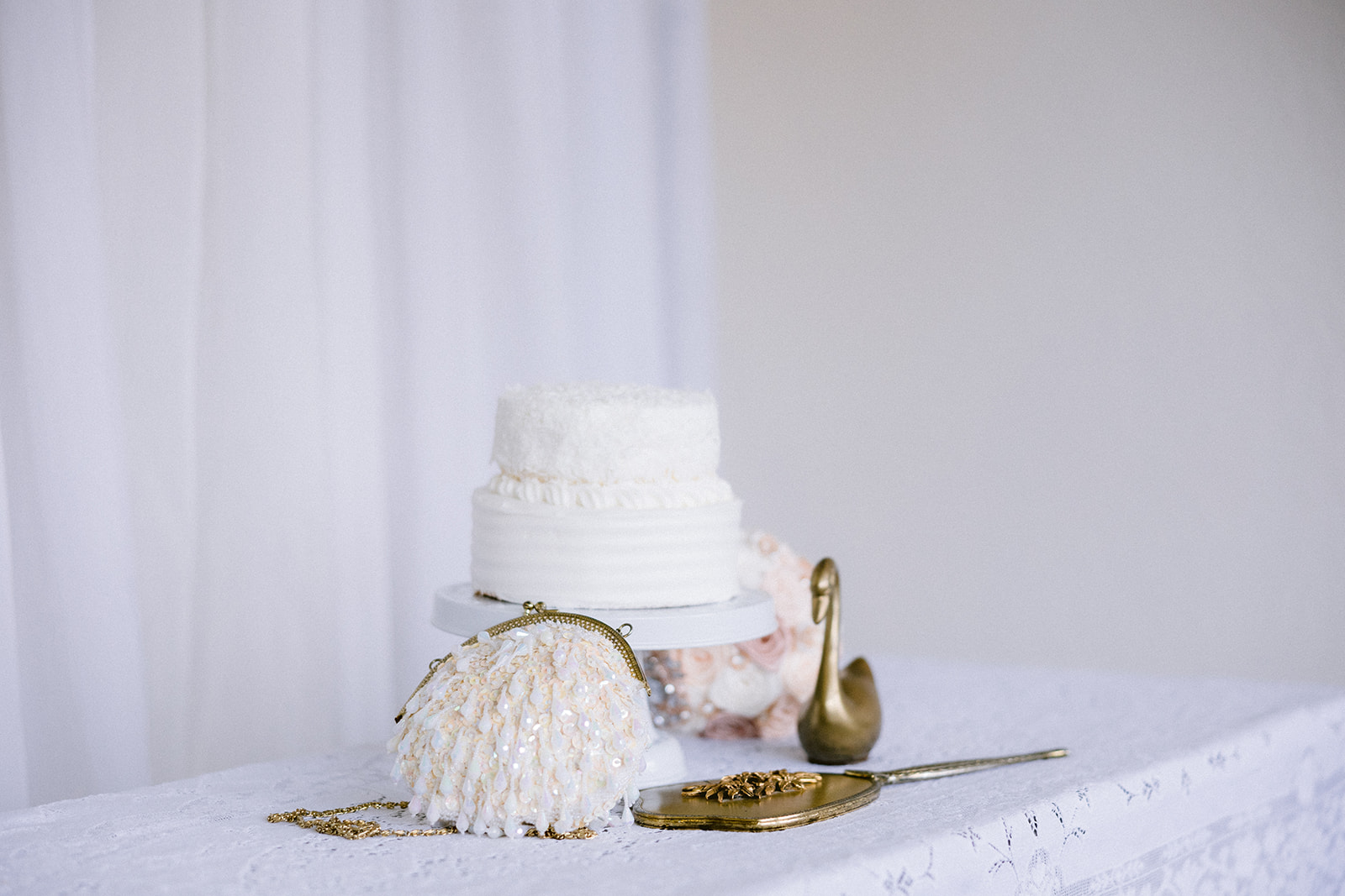 A cake and vintage bridal details help tie this Swan Lake editorial together.