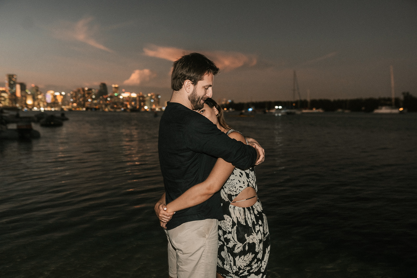 Direct flash photography with couple hugging and downtown Miami skyline in the background.