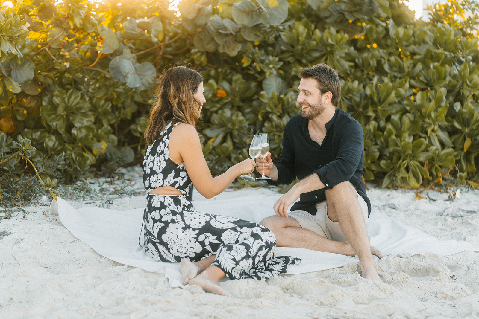 A couple having a romantic picnic at the beach in Miami Beach.