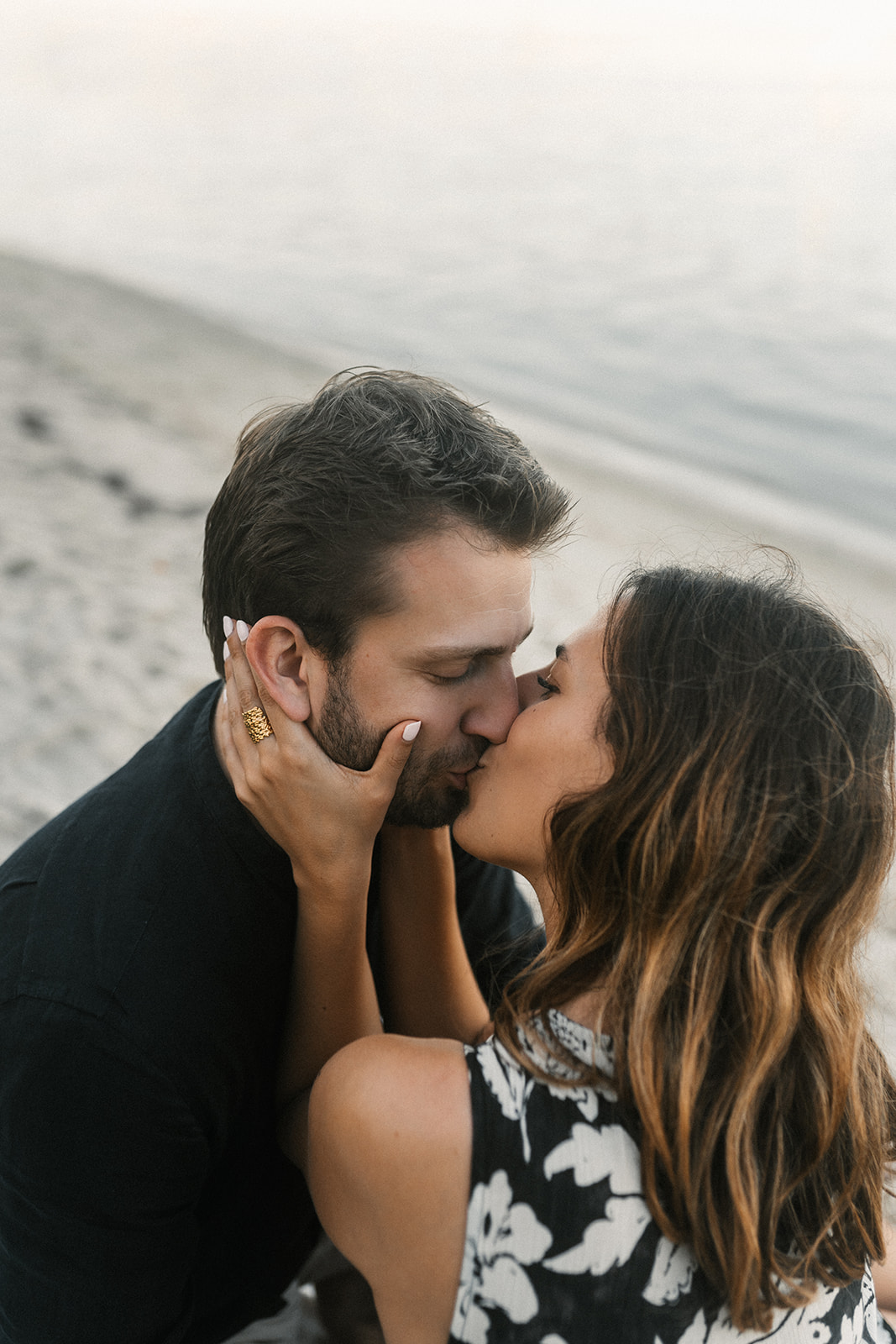 A couple kissing on the beach in Miami Beach.