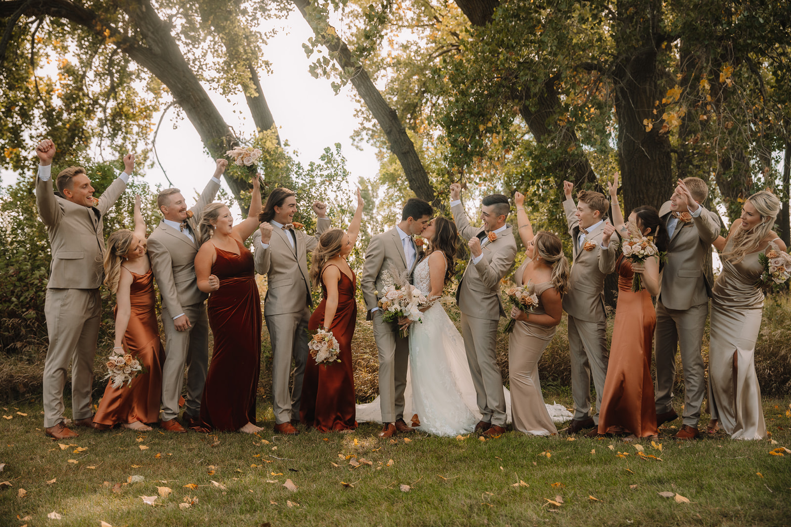 Wedding party photo with fall inspired dress theme at Lone Oak Farm Wedding Venue