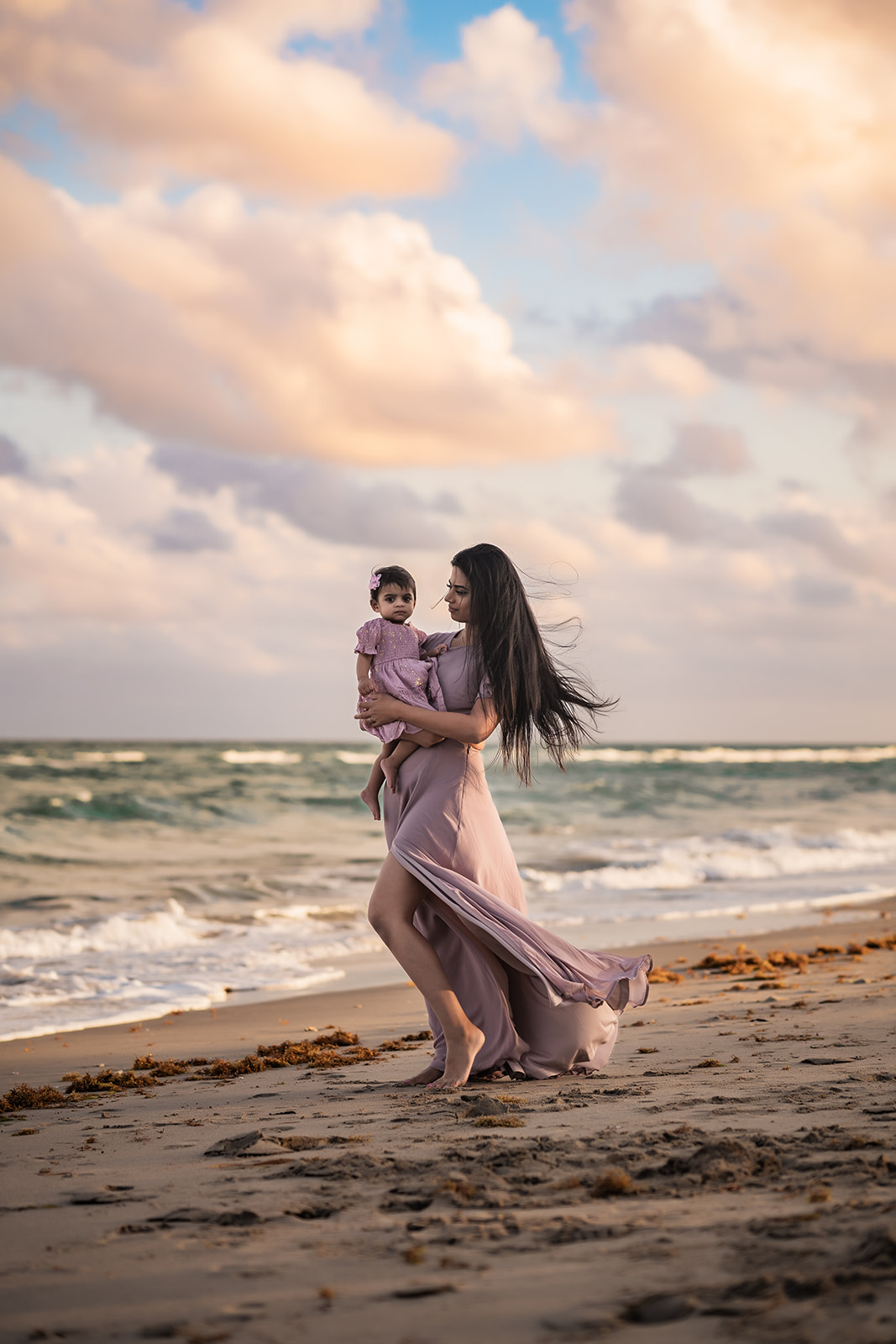 beach sunset mother daughter embrace