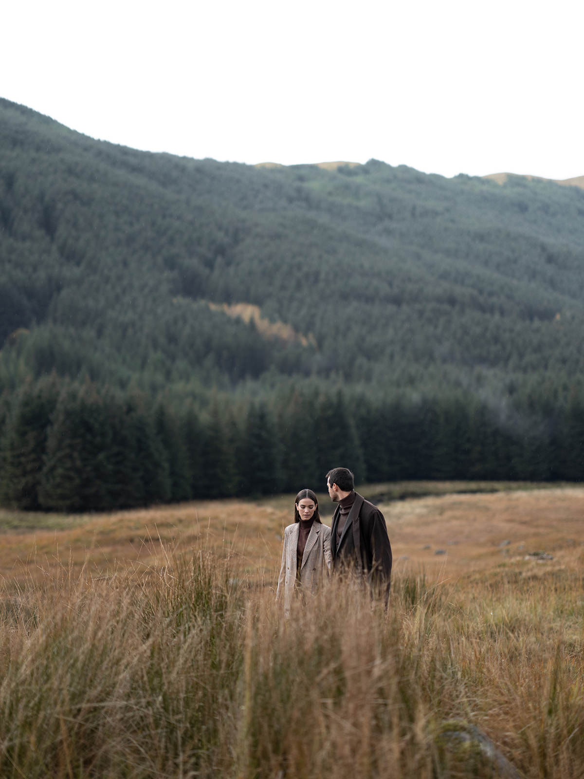 Couple taking their engagement pictures at Glen Dessary Estate in Scotland.