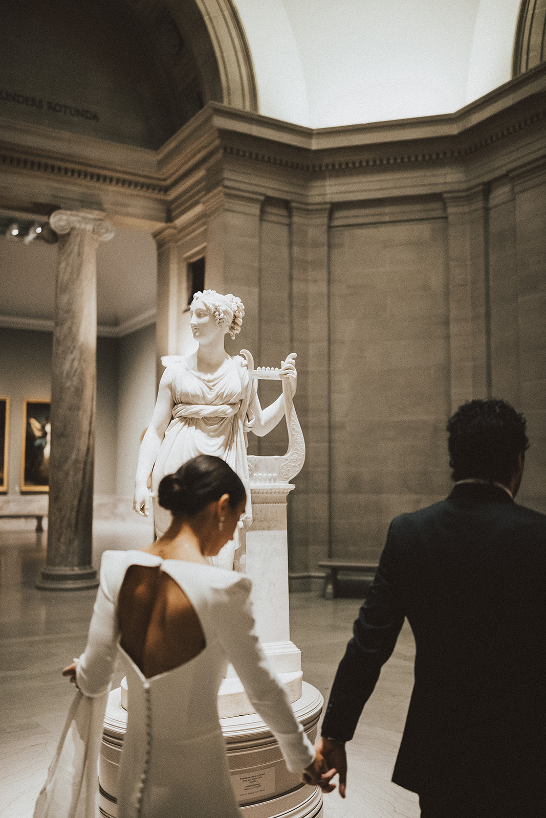 Bride and groom photographs inside Cleveland Museum of Art
