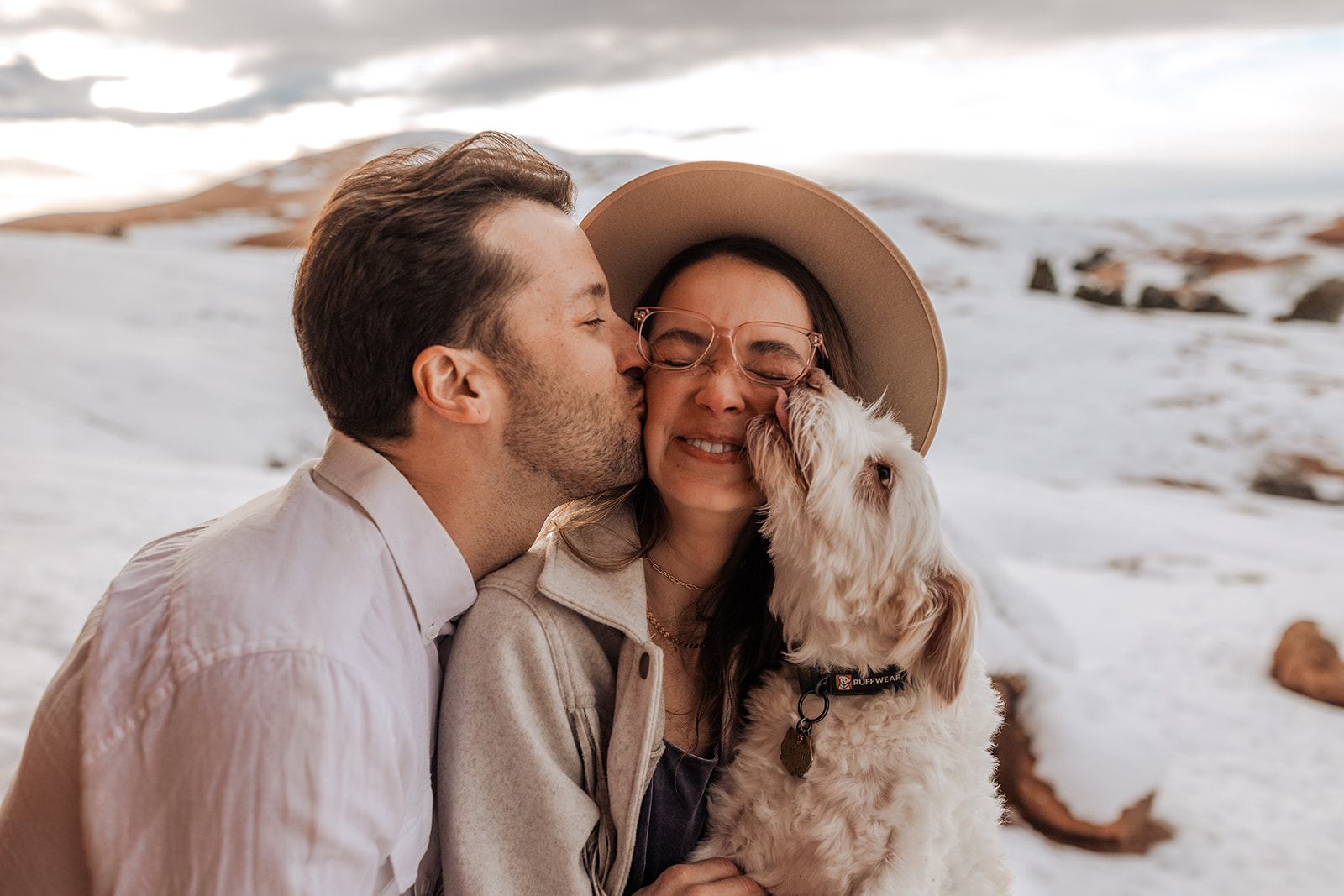 engaged couple with their dog in moab, utah