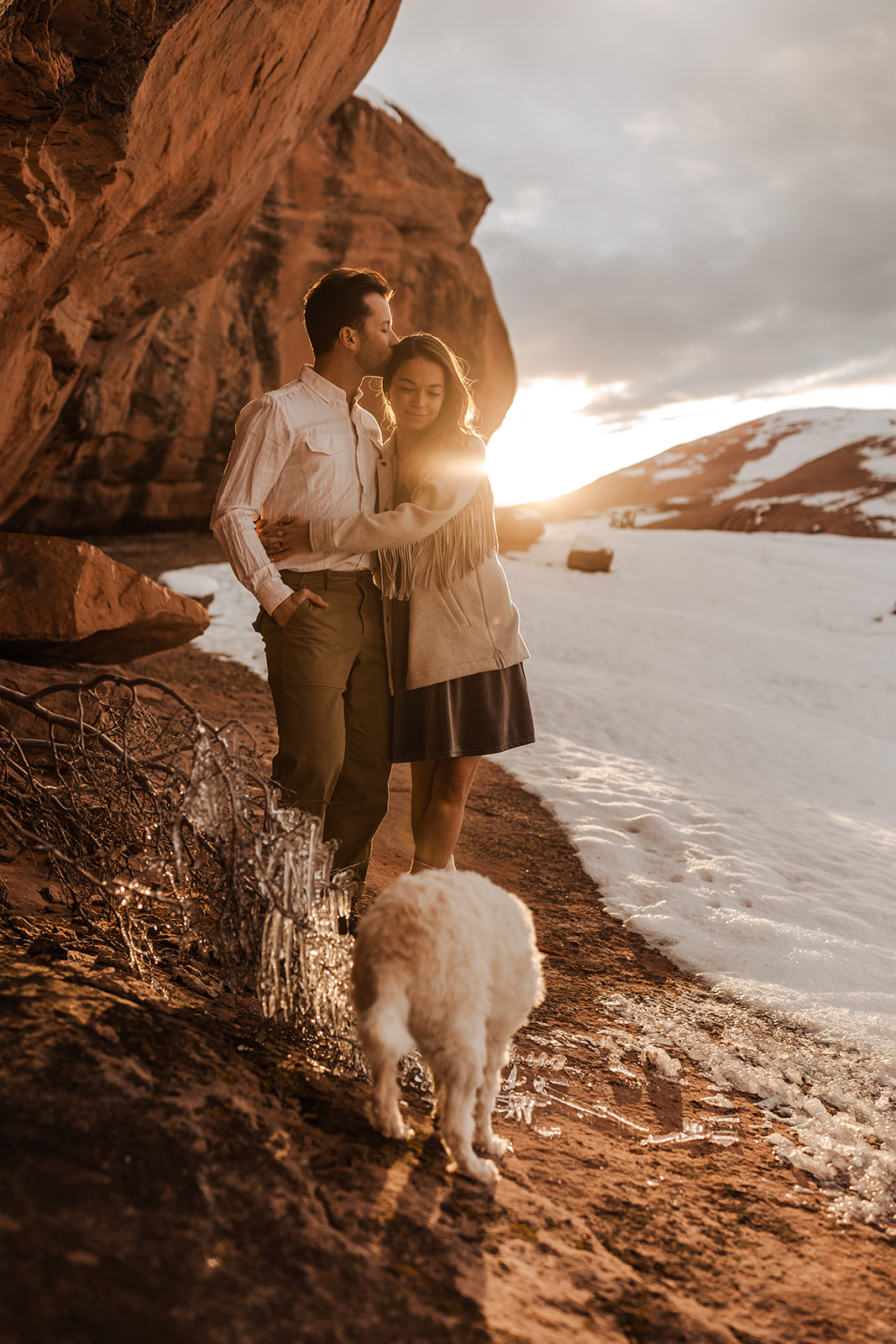 engaged couple with their dog in moab, utah