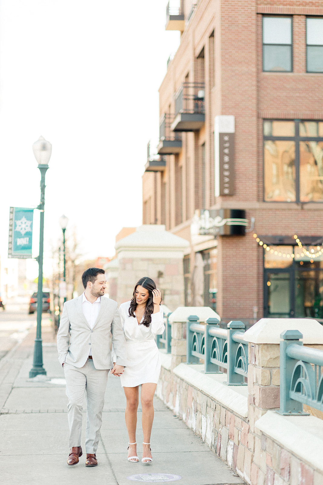 Couple walking down street in Castle Rock for engagement photos