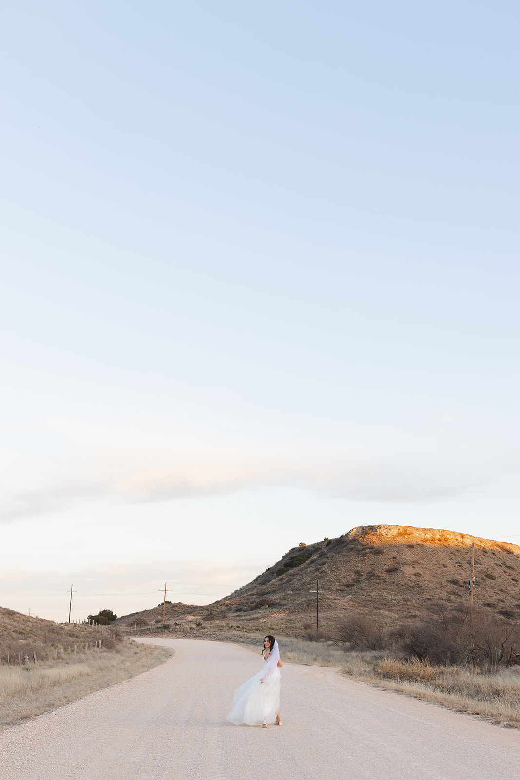 Bride in the distance on a dirt road in west texas
