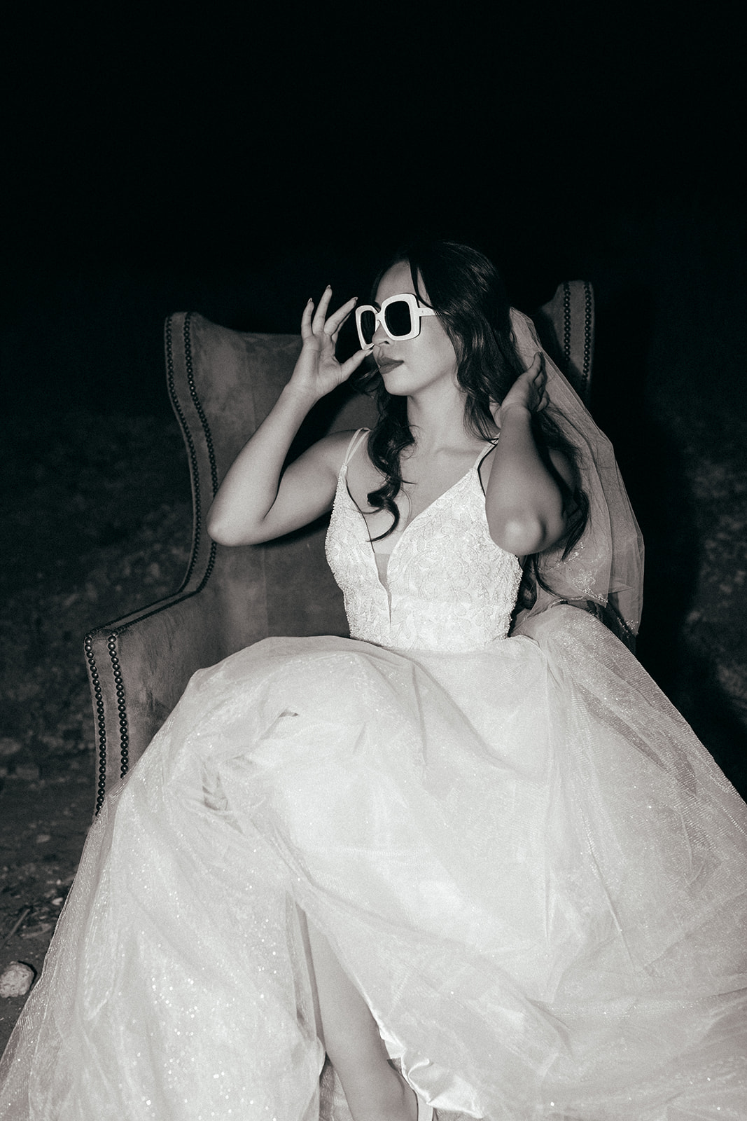 black and white flash photo of bride sitting in chair in west texas