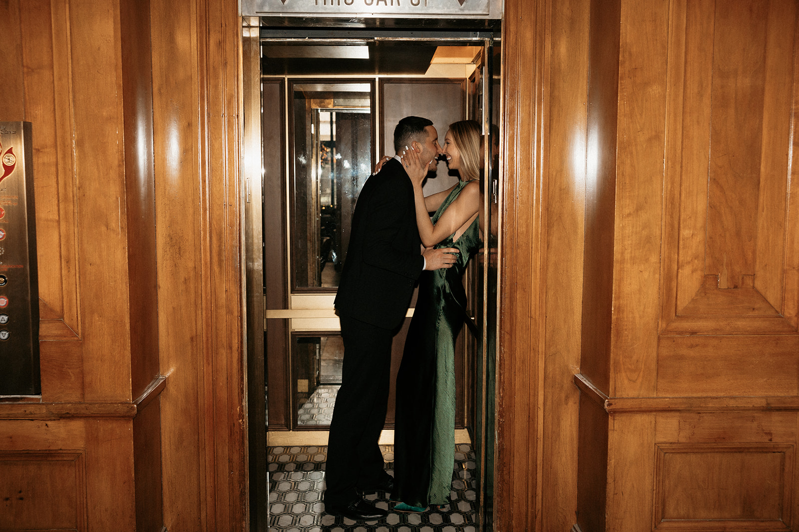 The couple sneaks a kiss in an elevator at the Hotel Fort Des Moines.