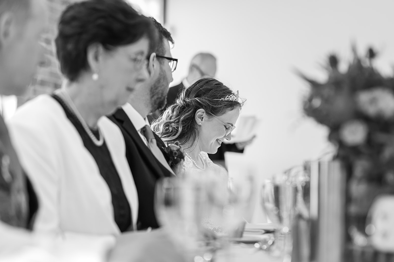 Black and white image of bride at top table
