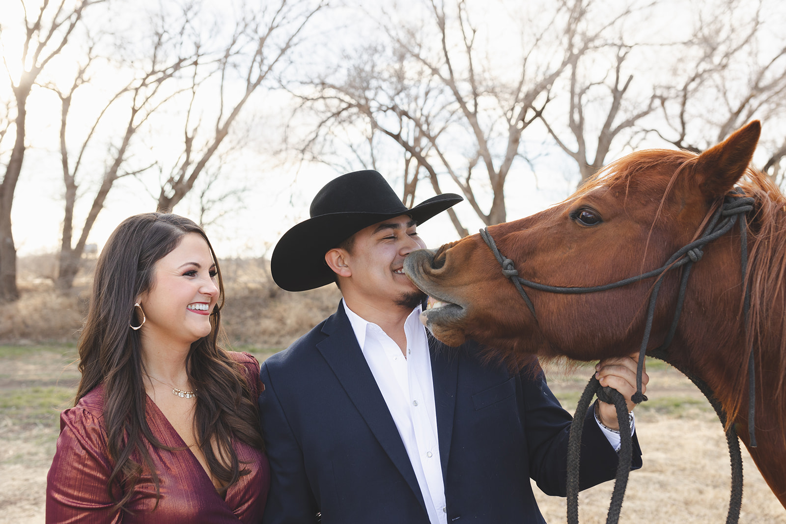 a couple at their engagement session with a horse