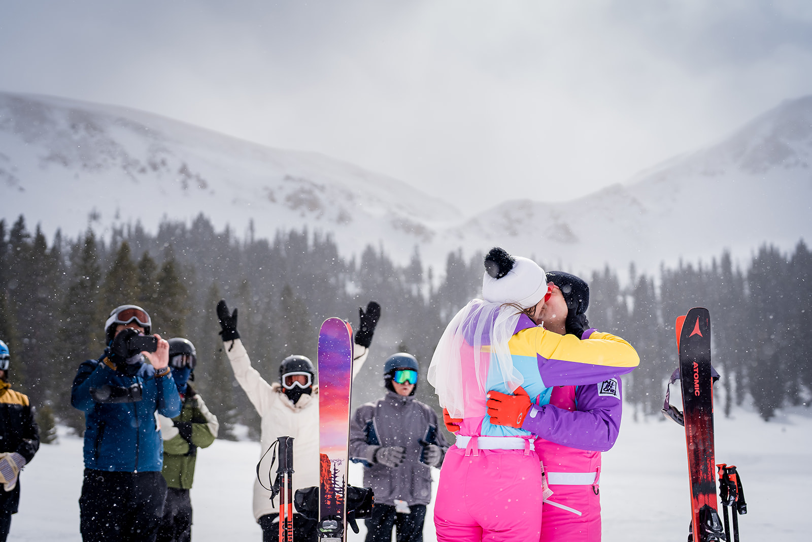 a couple shares their first kiss after their slopeside ski wedding at Loveland Ski Area's mountaintop matrimony