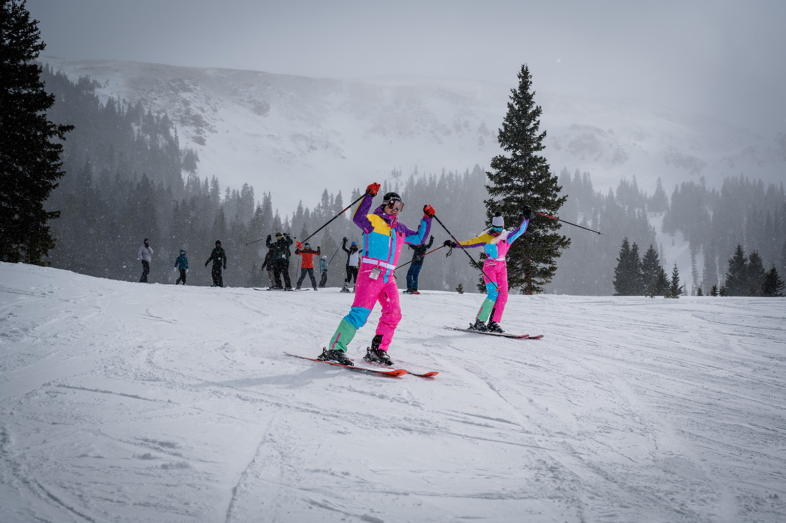 a bride and groom ski down after their ski wedding at Loveland Ski Area