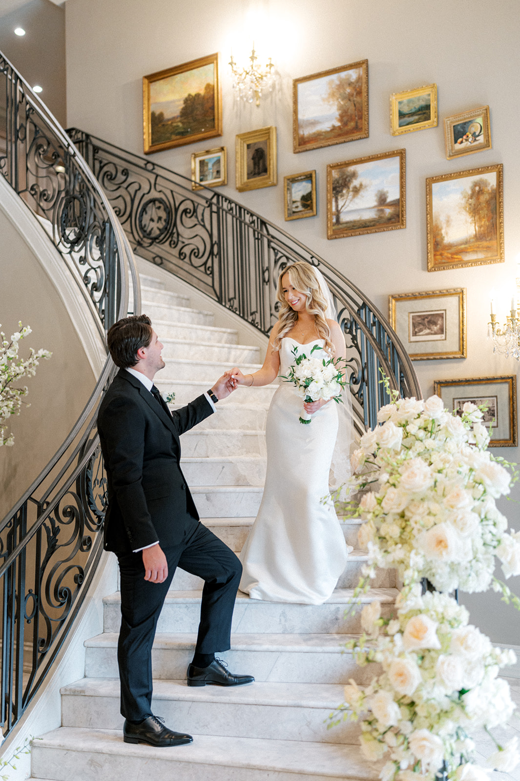 Bride and groom on grand staircase at Park Chateau wedding