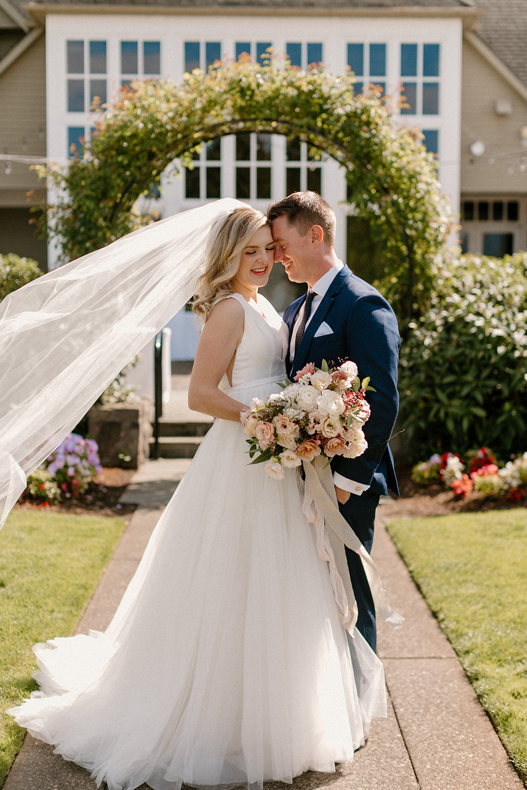A bride and groom share a sweet moment outside at their Oregon Golf Club wedding.