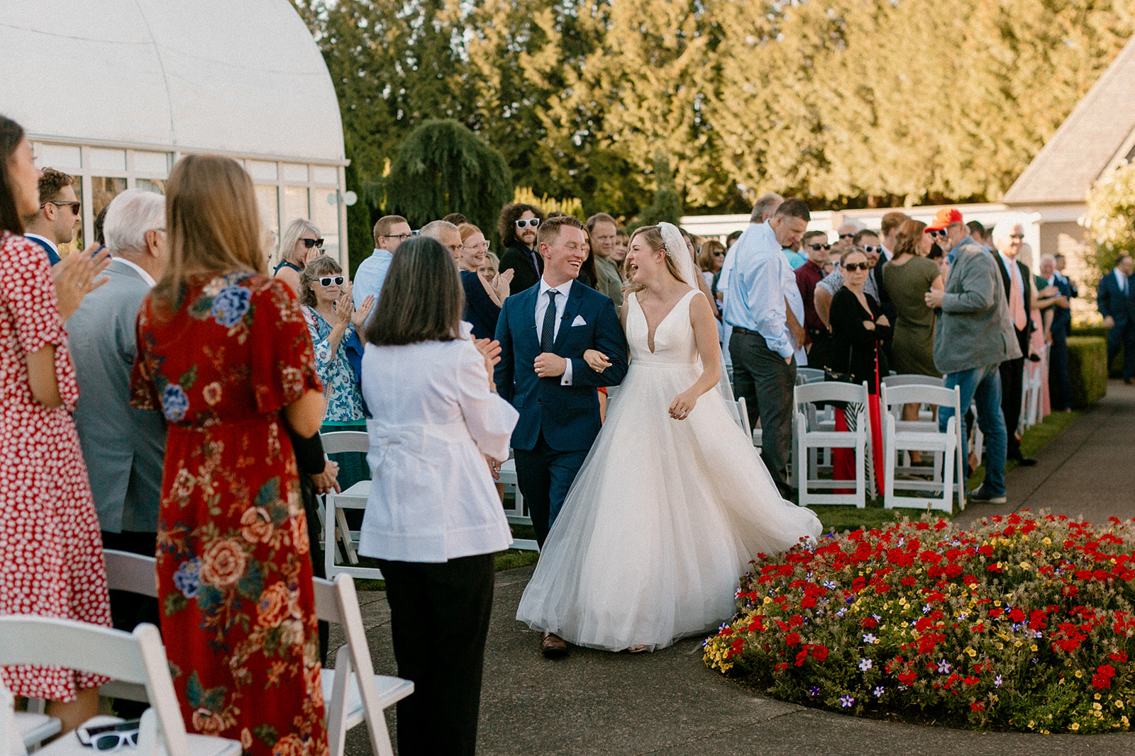 A bride and groom exit their wedding ceremony at the Oregon Golf Club. 
