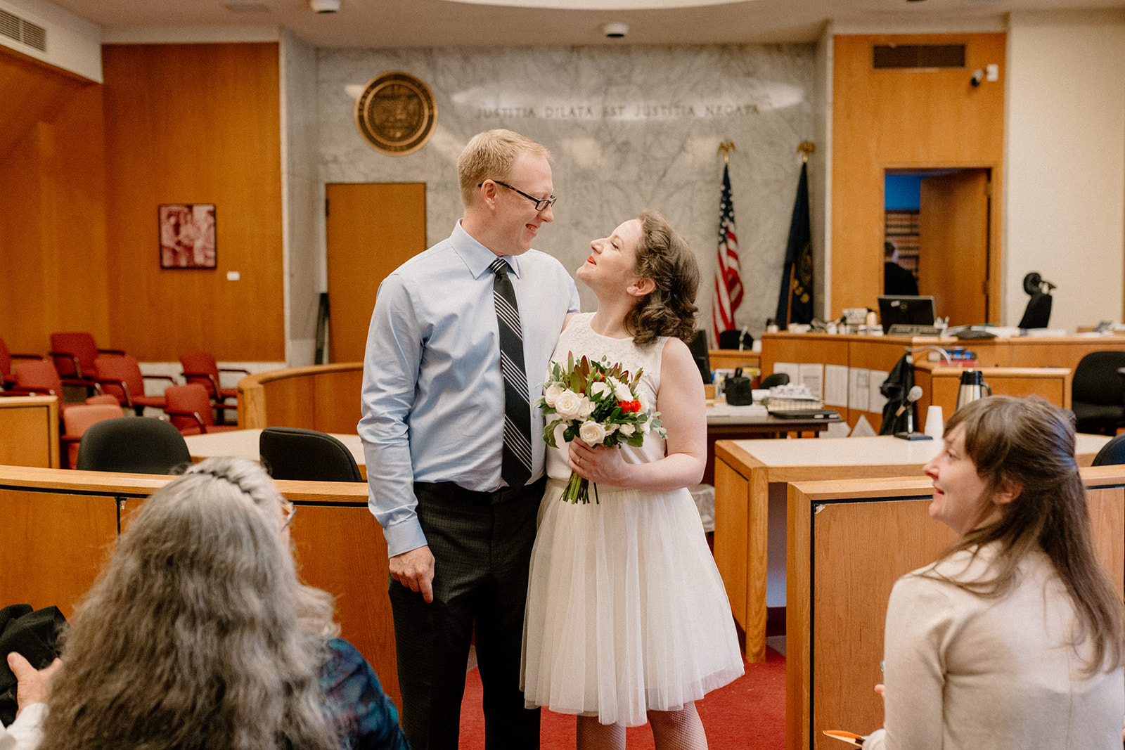 A bride and groom excited after their Portland courthouse elopement at the Multnomah county courthouse. 