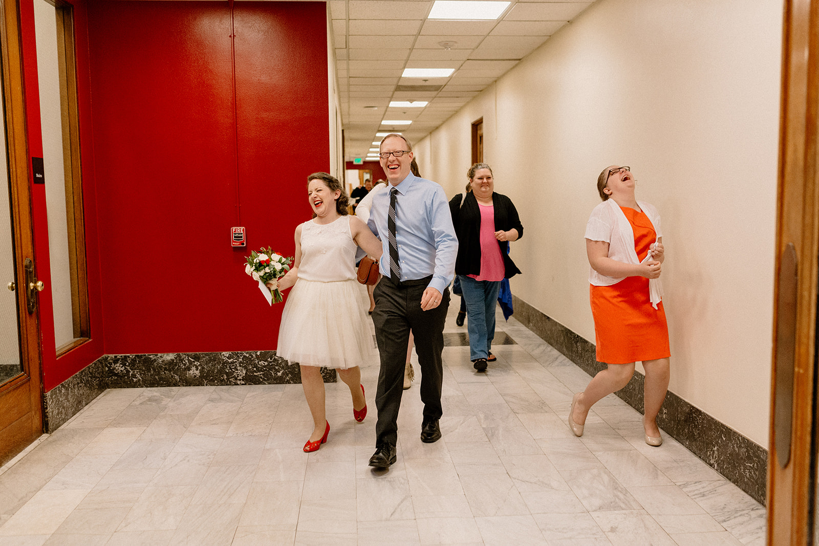 A bride and groom excited after their Portland courthouse elopement at the Multnomah county courthouse. 