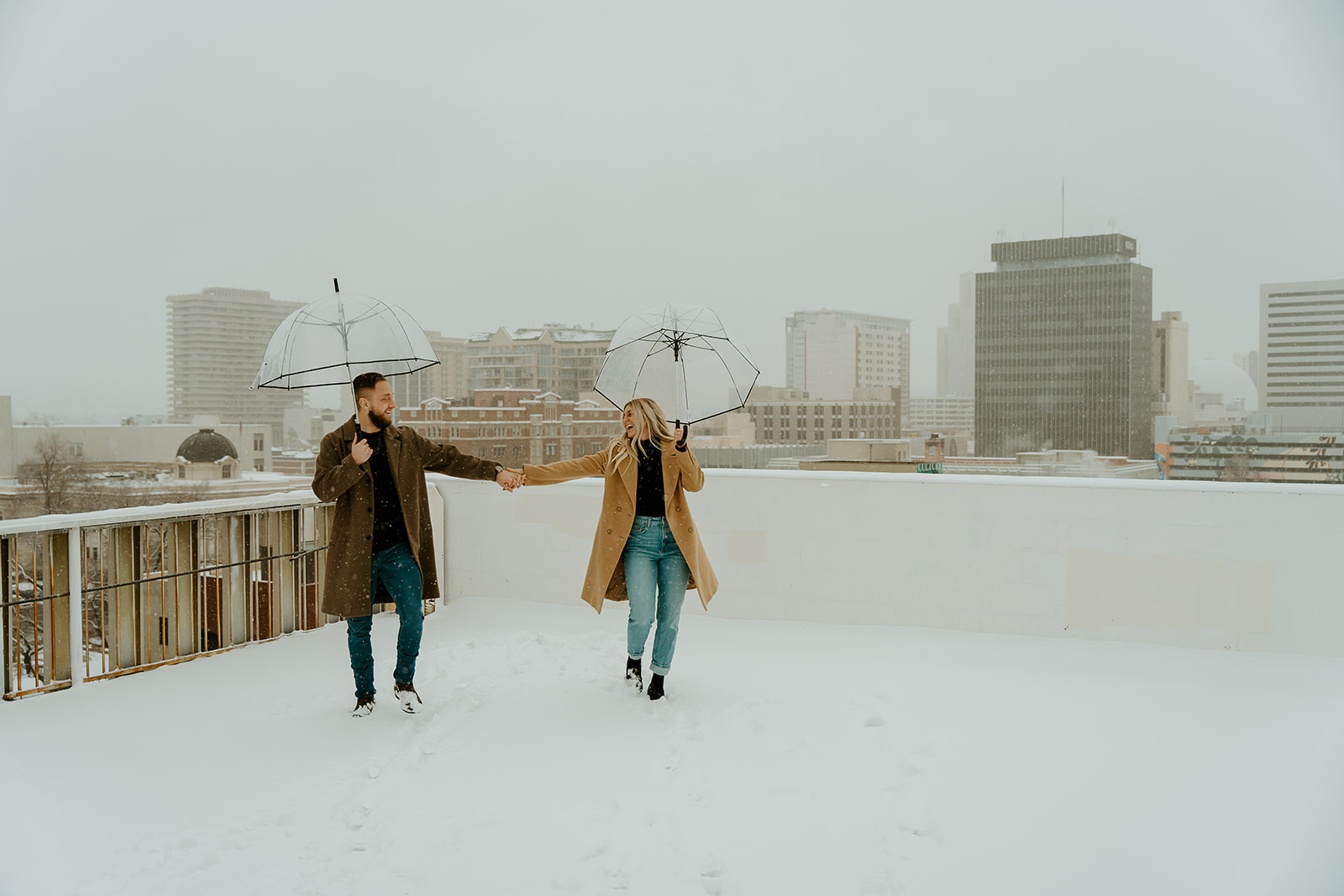 walking alongside downtown reno as the snow fell during their romantic couples session