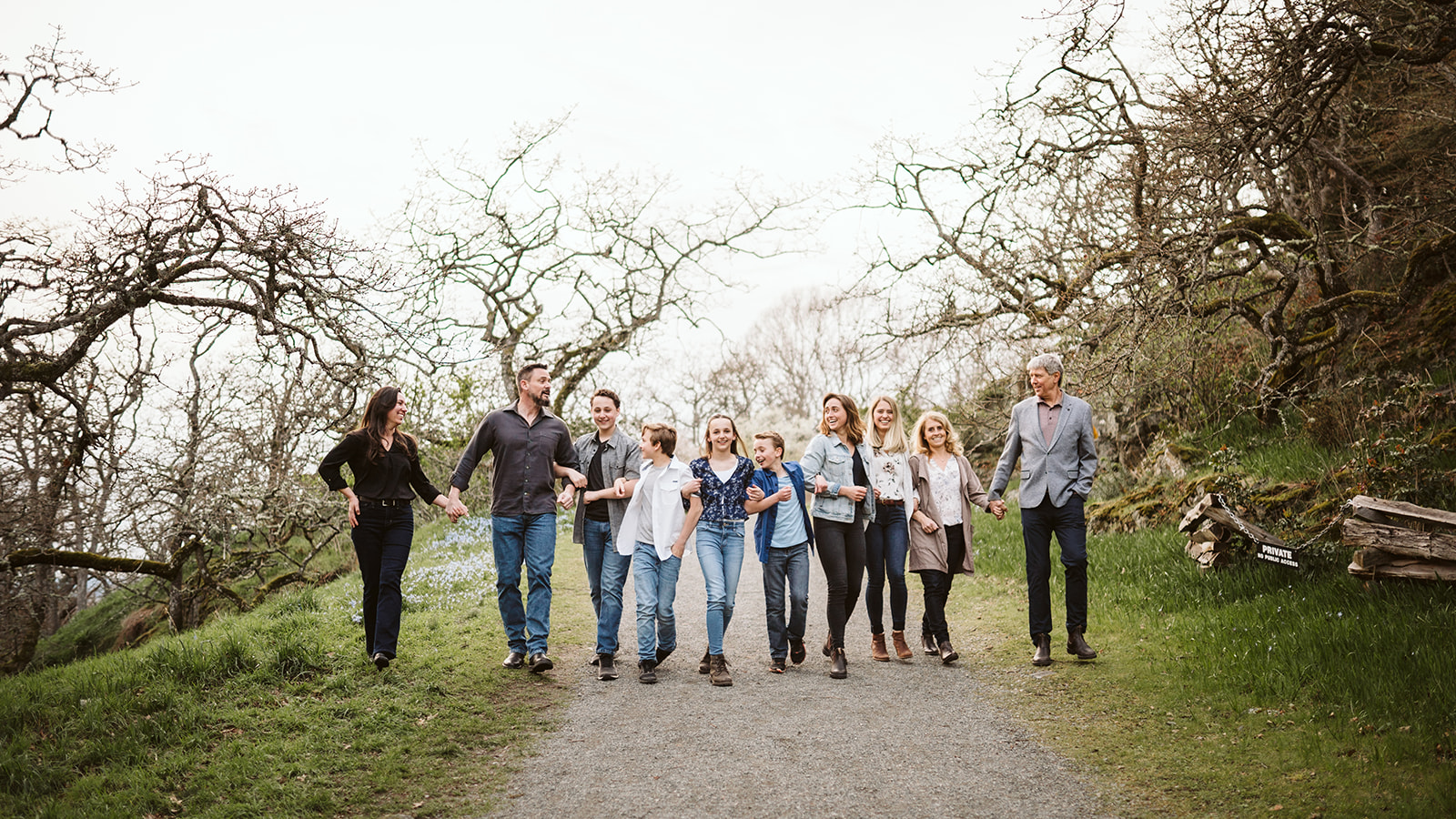 Large family group walking arm in arm and laughing