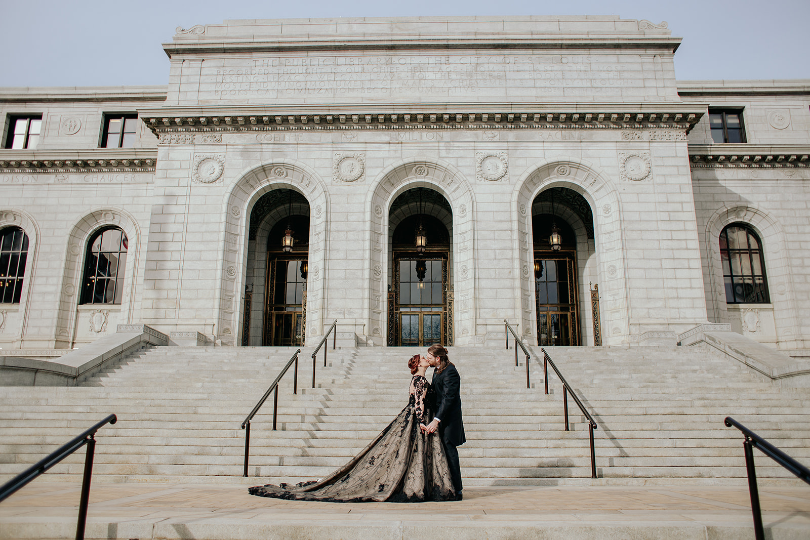 A couple who married in St. Louis kiss in front of the downtown library