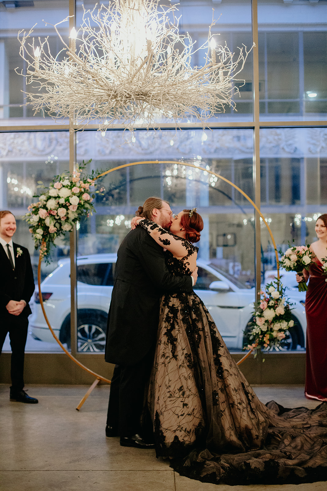 A couple shares their first kiss as they marry under twinkling lights