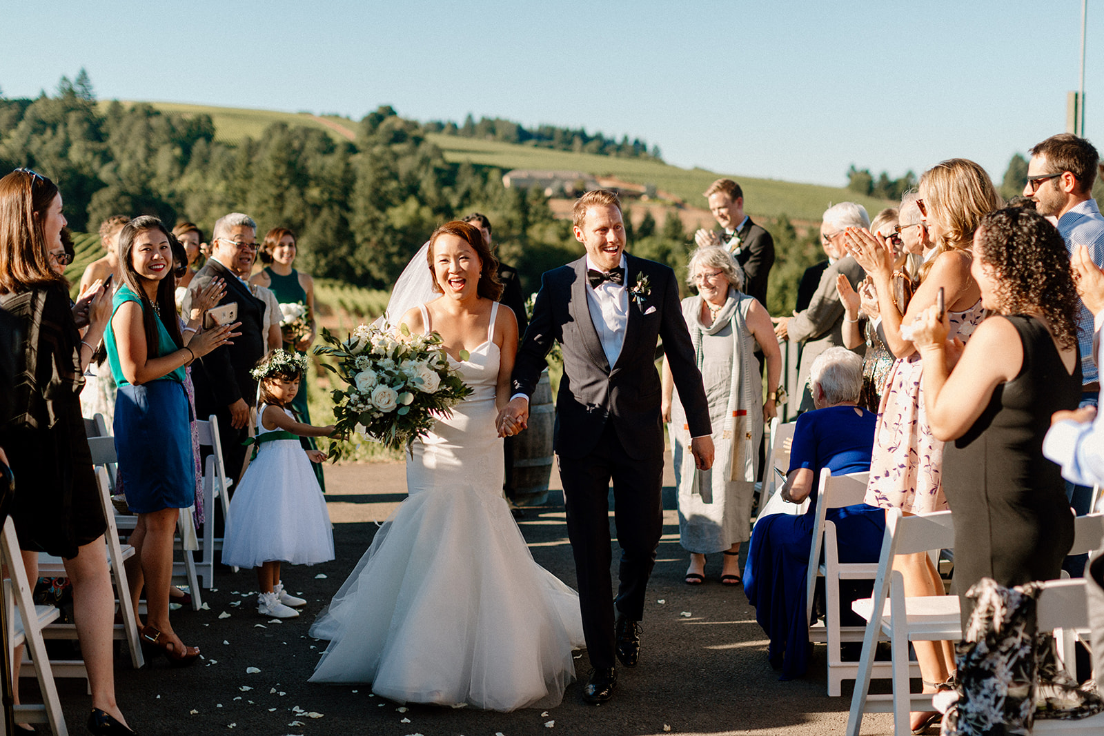 A bride and groom walking down the aisle at their Sokol Blosser winery wedding ceremony.
