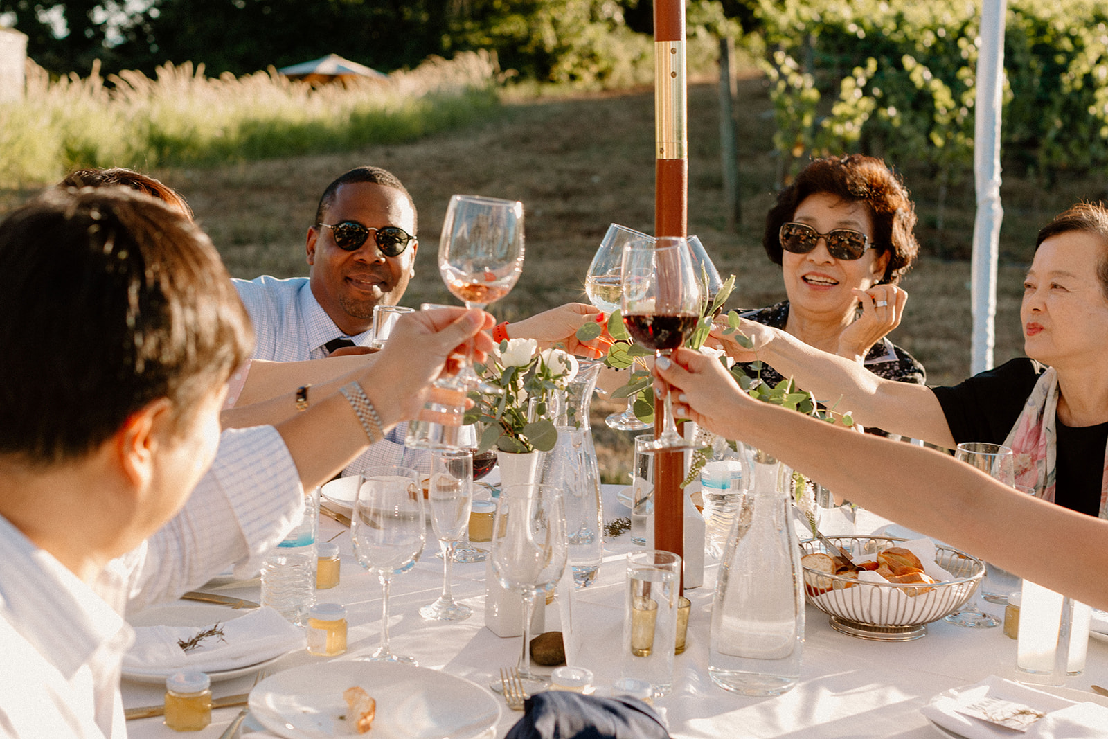 Guests toasting at a Sokal Blosser winery wedding. 