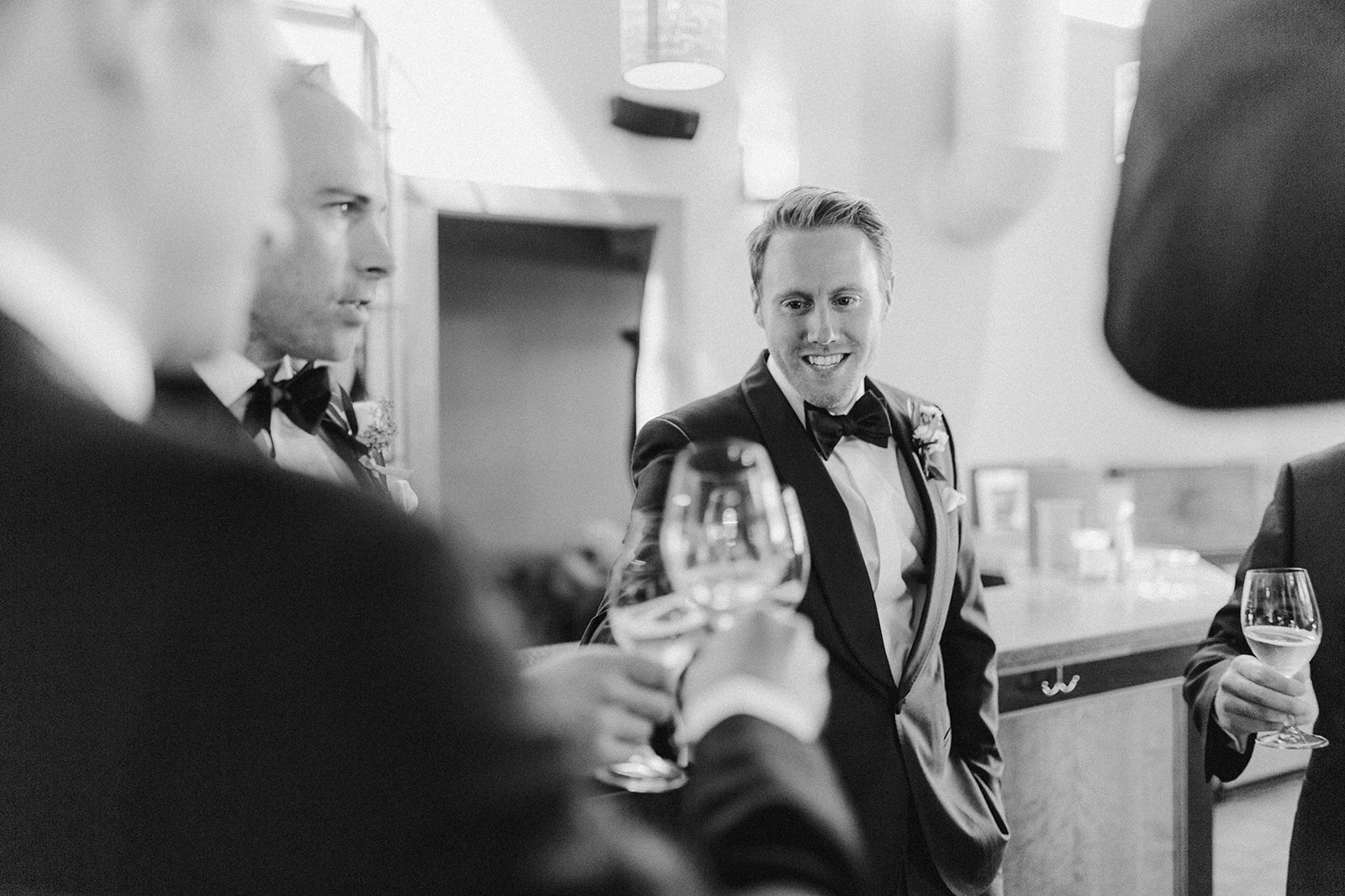 A groom cheering with his groomsmen at his Sokol Blosser winery wedding. 