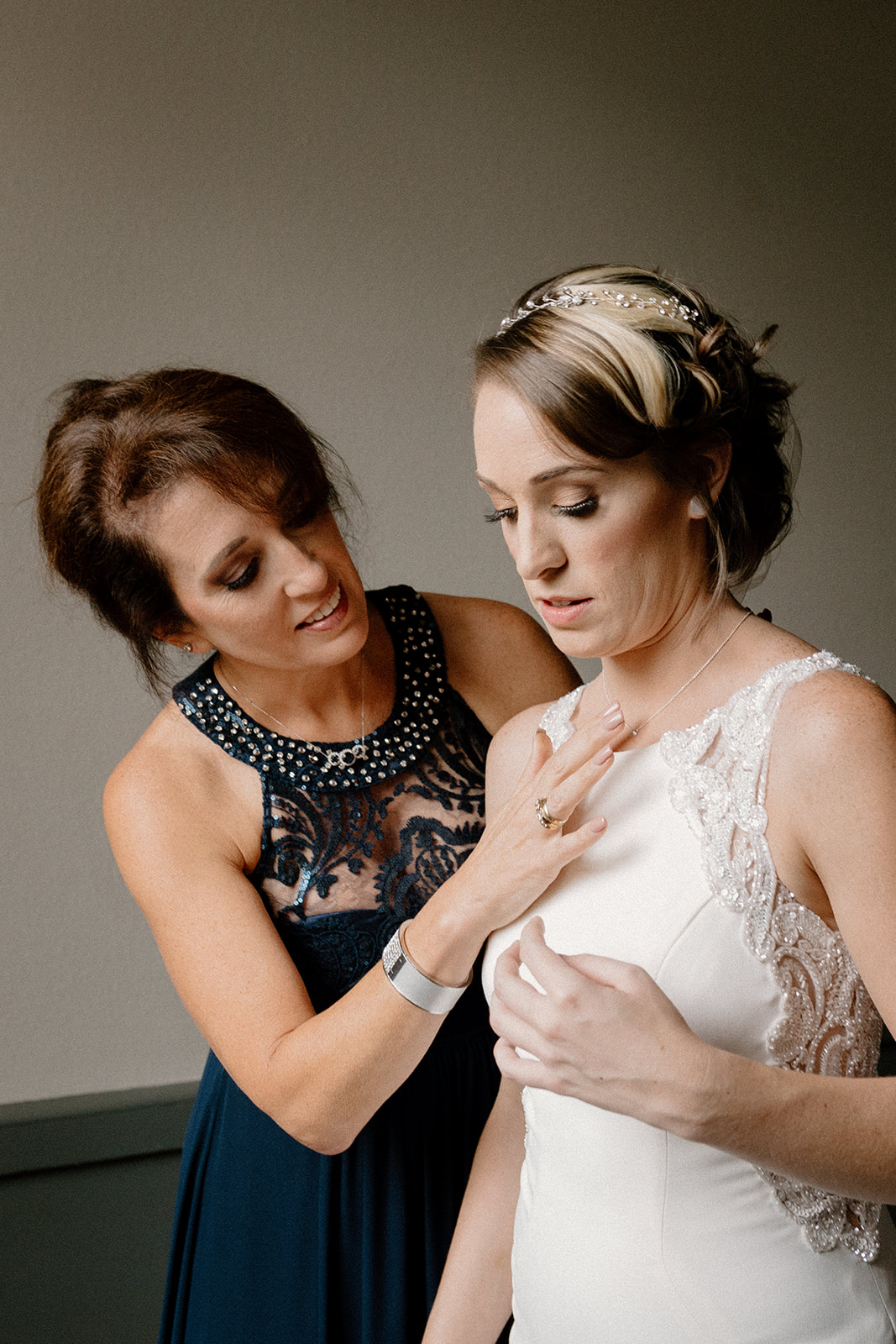 A mother helping a bride get ready for her wedding at the Sentinel Hotel. 