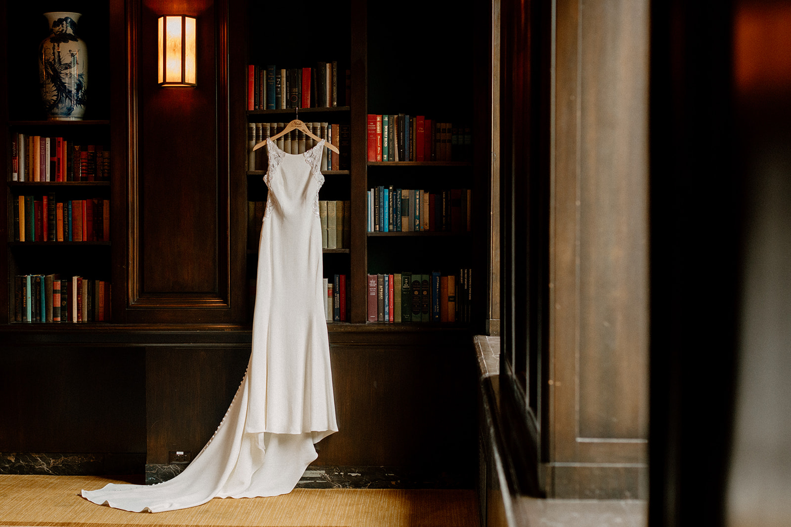 A wedding dress hanging in the Library room at the Sentinel Hotel in Portland, OR. 