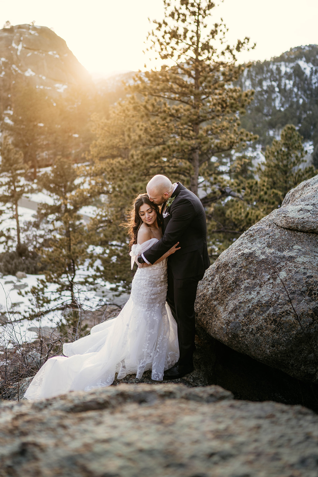 Golden hour couples photos in the forest at winter mountain wedding at Black Canyon Inn in Estes Park, Colorado