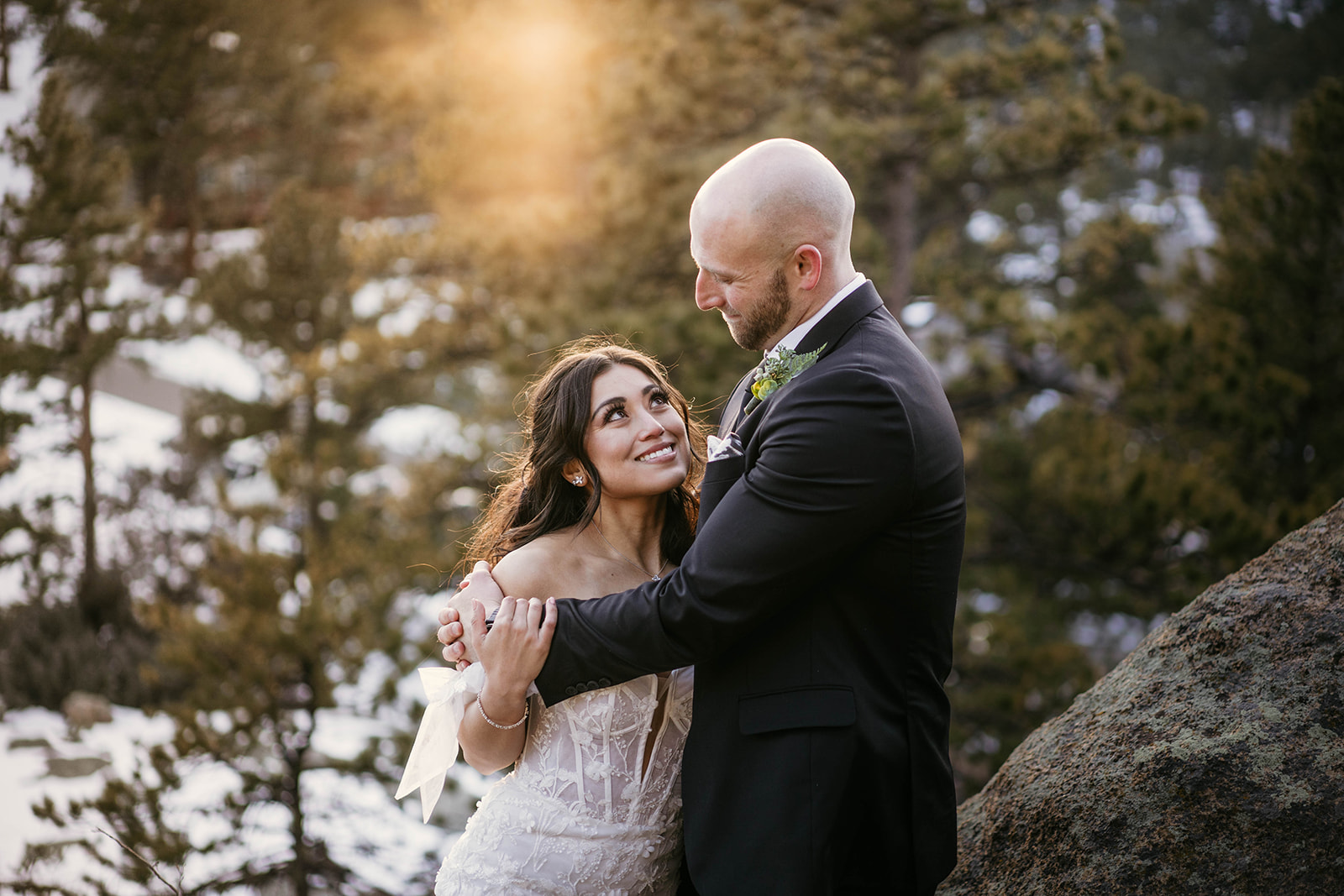 Romantic golden hour couples photos in the forest at winter mountain wedding at Black Canyon Inn in Estes Park, Colorado