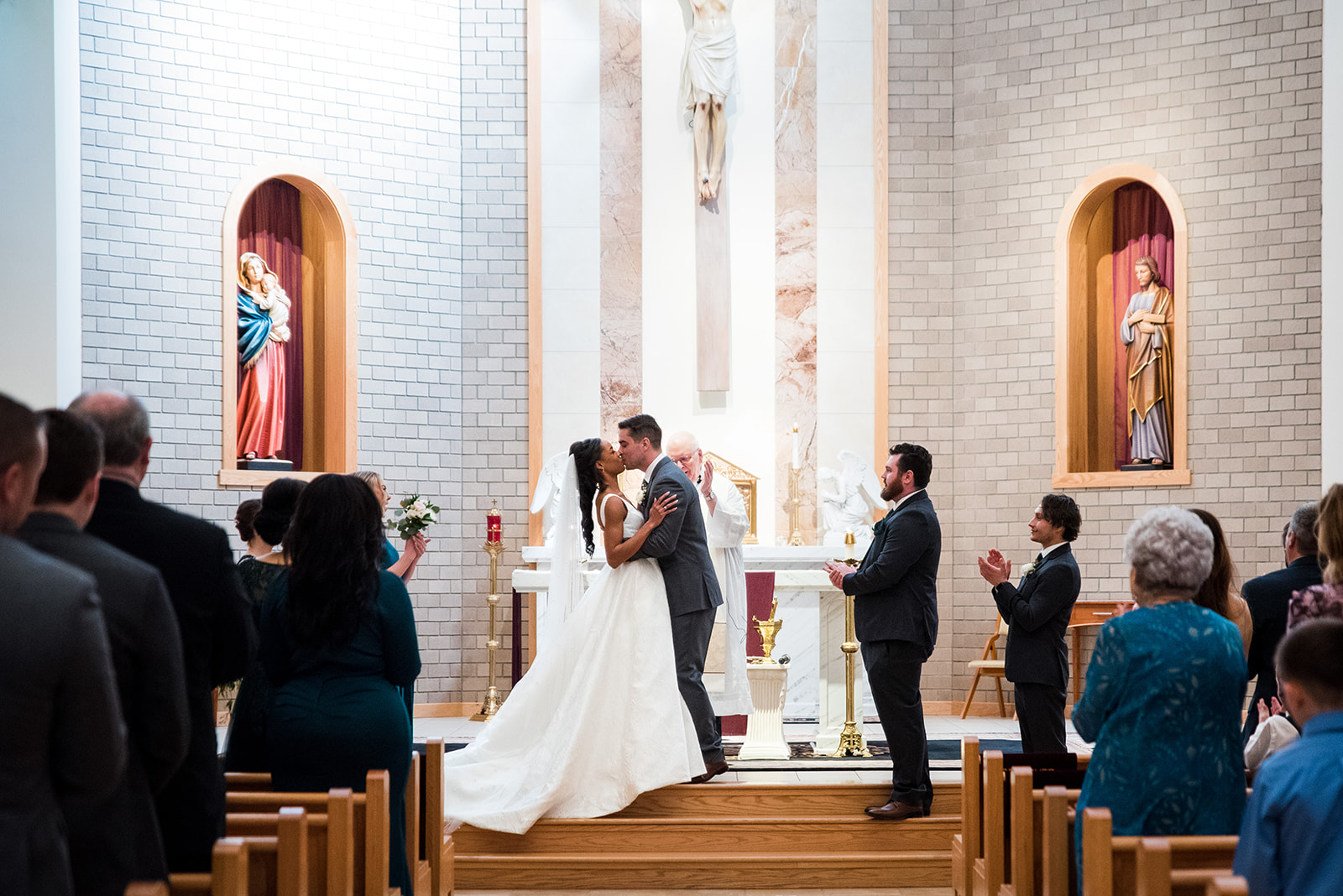 Bride and groom share their first kiss on the church alter after the ceremony.