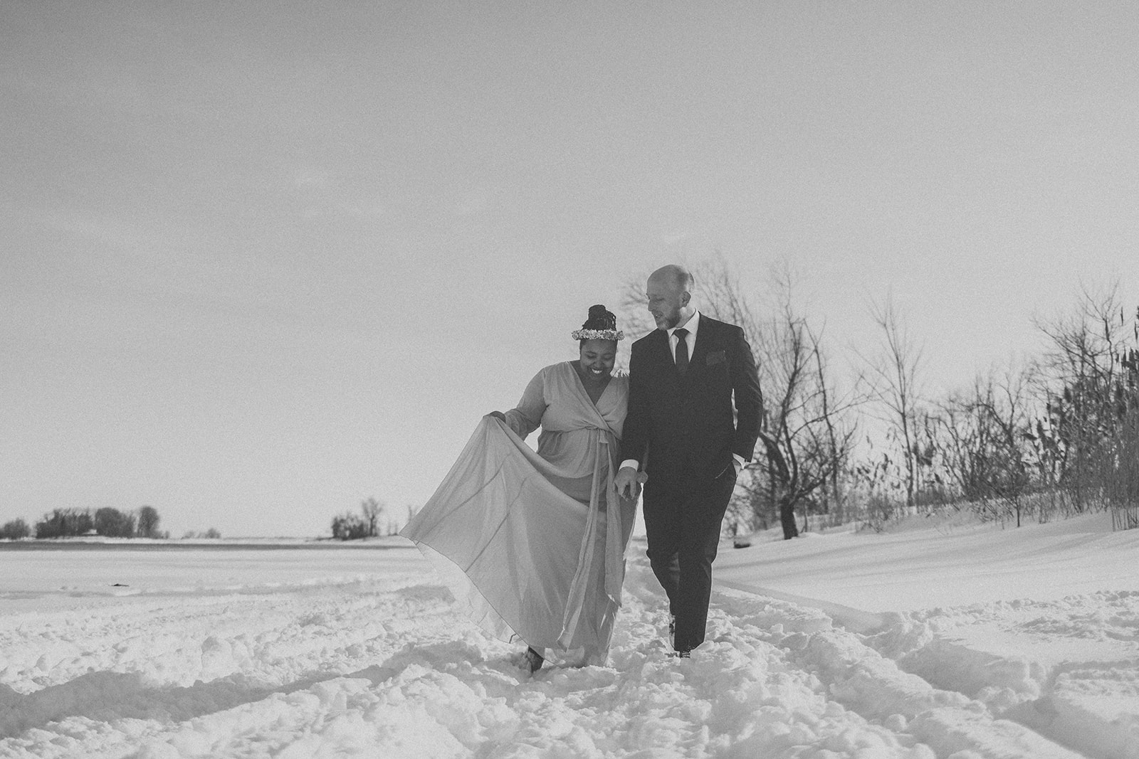 A couple who eloped in Montreal, Canada walk along the St. Lawrence River after saying their vows.