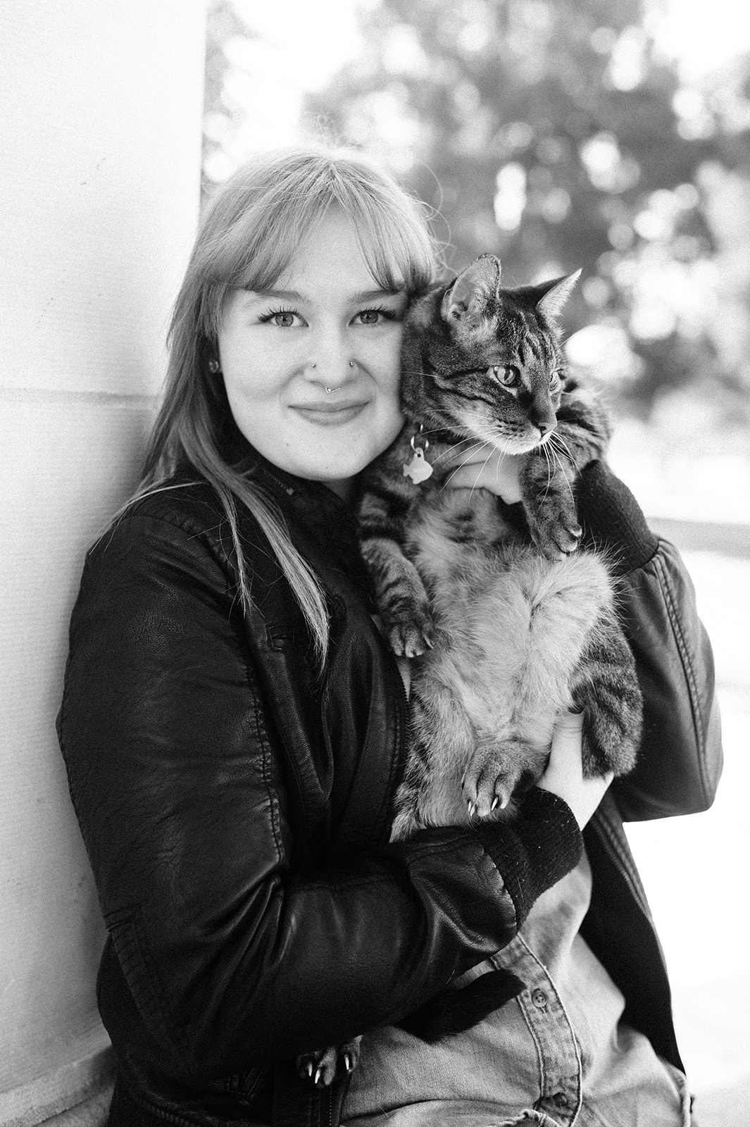 black and white photo of a woman with her cat