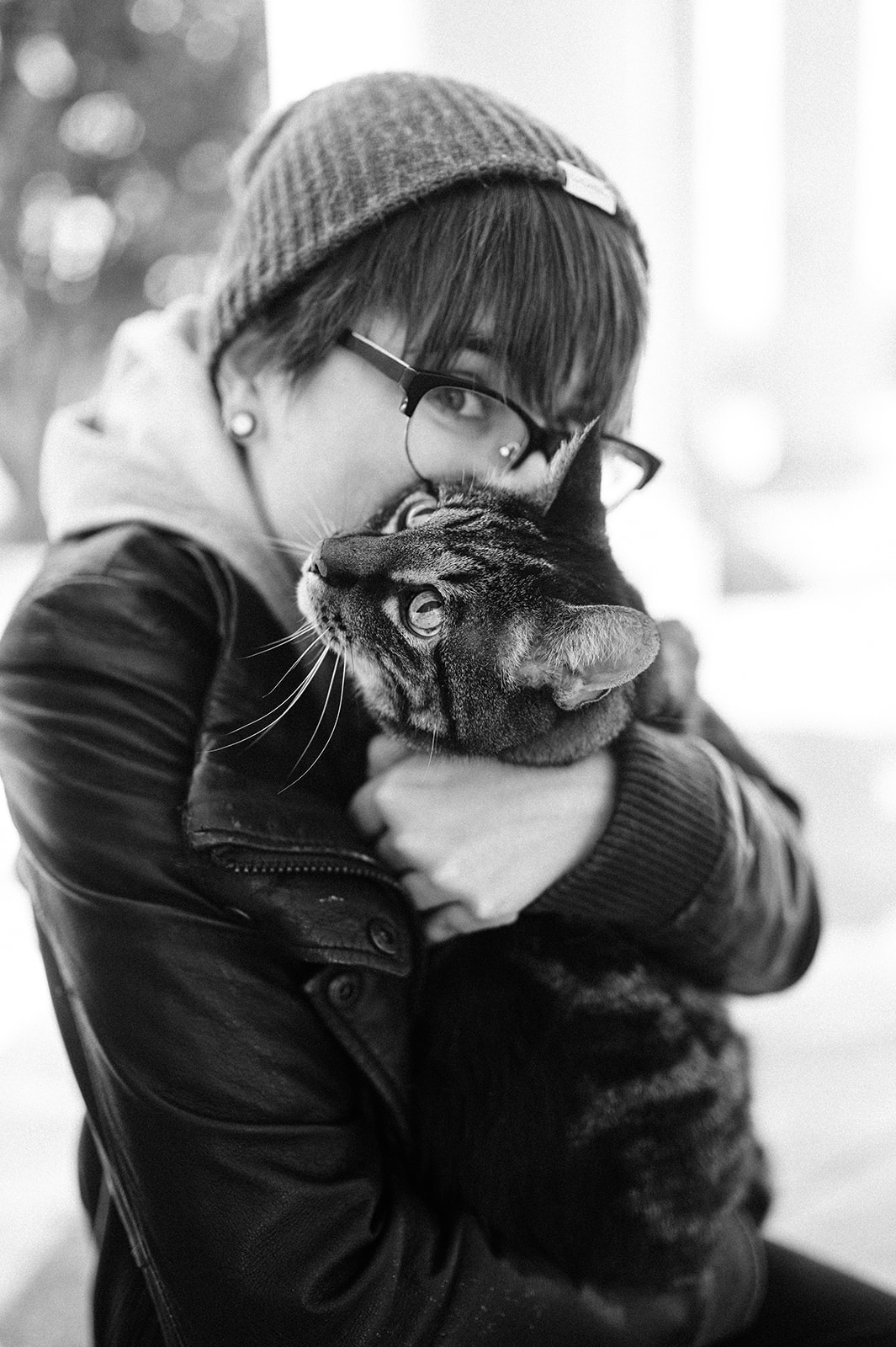 black and white photo of a woman with her cat