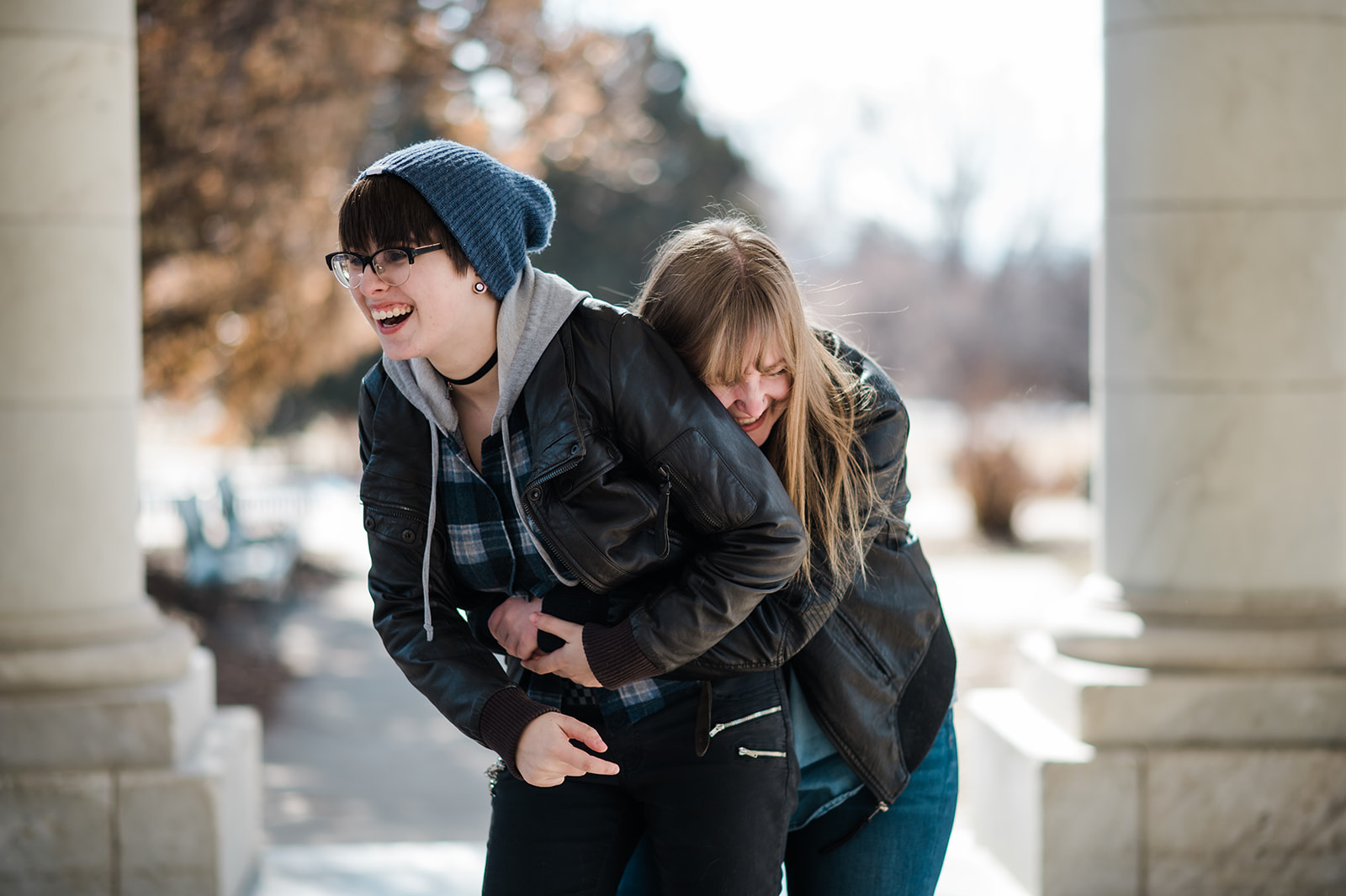 photo a woman surprising her girlfriend with an ambush hug