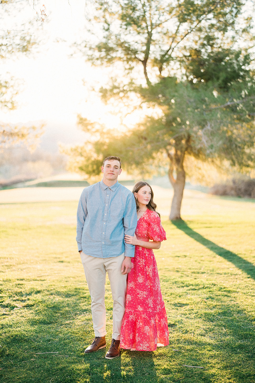 couple looks at camera backlit by sun