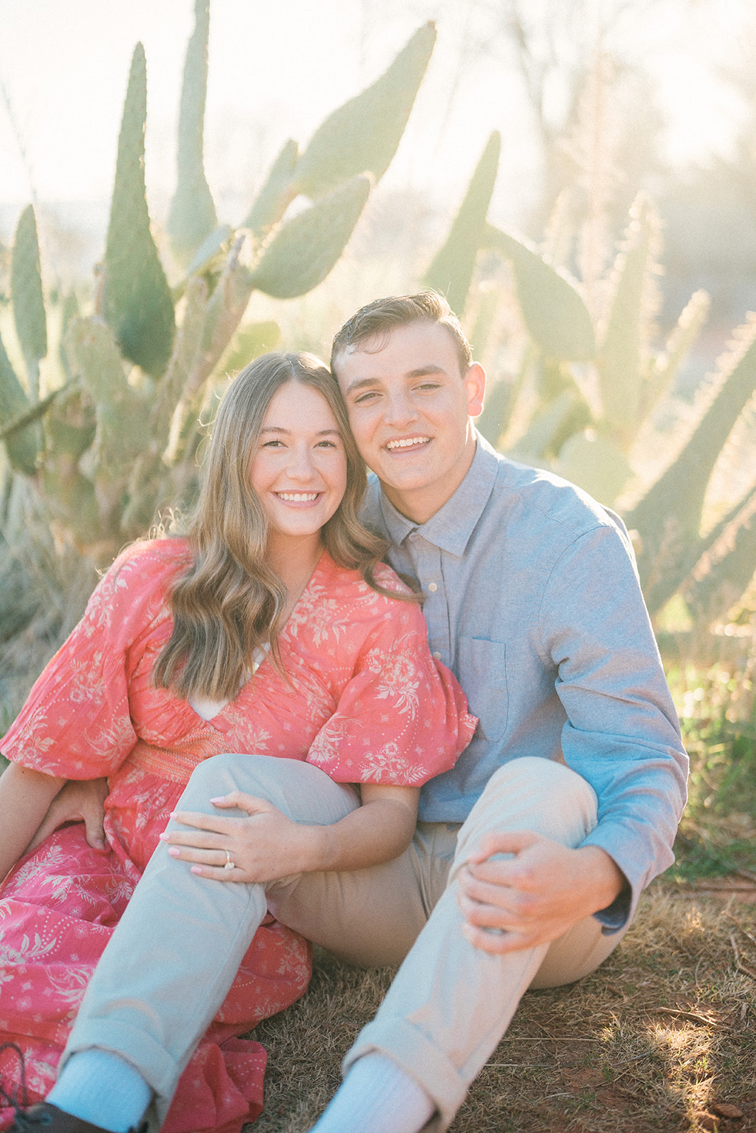 engaged couple in front of cactus